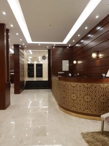 a lobby with a reception desk in a building at Waqet AlFakhama Furnished Apartments in Tabuk