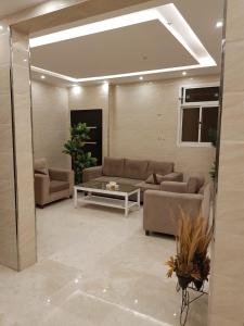 sala de estar con sofás y mesa en Waqet AlFakhama Furnished Apartments, en Tabuk