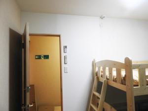 a bedroom with a bunk bed and a door to a room at 冨の露～とみのつゆ～ in Setouchi