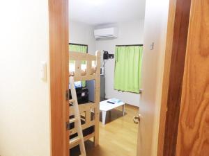 a room with a bunk bed and a room with a door at 冨の露～とみのつゆ～ in Setouchi