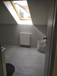 an attic room with a skylight and a radiator at Apartment 2 in Hrabušice