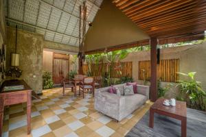 a living room filled with lots of furniture at Space Villas Bali in Seminyak