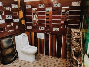 a bathroom with a toilet in a room at Forest wood-Port Barton in San Vicente +89 photos
