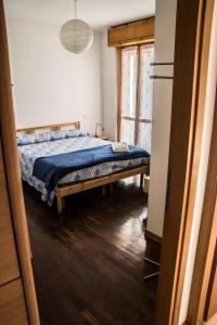 a bedroom with a bed with a blue comforter at New A Casa da Ida in Parma