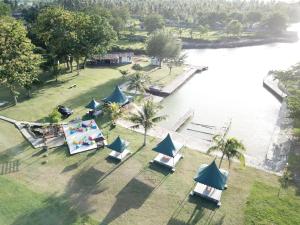 an aerial view of a park with tents and a lake at Sanghyang Indah Spa Resort in Anyer