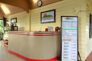 a restaurant with a counter and a menu on the wall at Enchanted River Rock Island Resort in Hinatuan