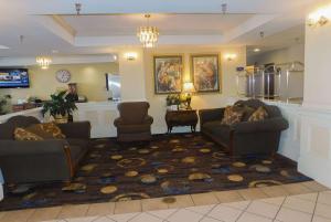 a large living room with two couches and a rug at Days Inn & Suites by Wyndham Pocahontas in Pocahontas