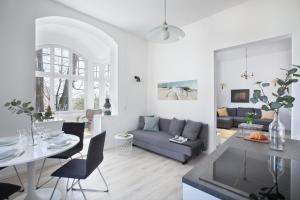 a living room with a couch and a table at RJ Apartments Chopina in Sopot