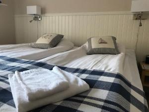 two beds with towels on them in a room at Stiftsgården i Rättvik in Rättvik