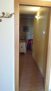 korytarzem prowadzącym do sypialni z łóżkiem w obiekcie Garda Sol SPA Hotel & Appartamenti w mieście Toscolano Maderno