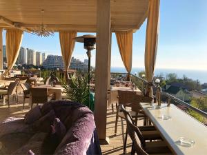 a balcony with tables and chairs and a view of the city at For You in Odesa