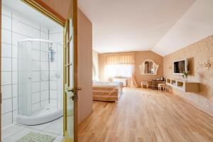 a bedroom with a bed and a bathroom with a shower at Adelės Vila in Palanga +63 photos