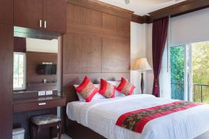 a bedroom with a large bed with red pillows at Baan Intira Pool Villa in Ao Nang Beach +65 photos