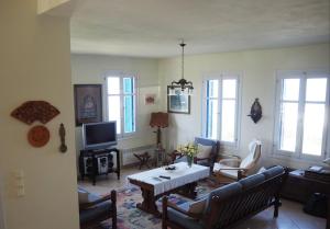 a living room with a couch and a table at Villa Natasa in Batsi
