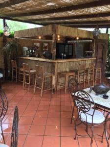 a patio with tables and chairs and a kitchen at Hotel Atlantic in Marina di Carrara