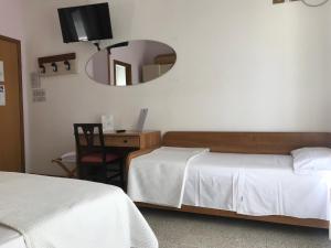 Postel nebo postele na pokoji v ubytování Pensione Imperia
