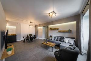 a living room with a couch and a table at Groble Residence WAWELOFTS in Krakow