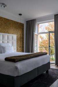 Tempat tidur dalam kamar di Hotel Rubens-Grote Markt