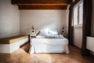 a bedroom with two beds and a window at Tenuta Kyrios in Borgagne
