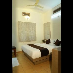 Voodi või voodid majutusasutuse Dakshin Ghats toas