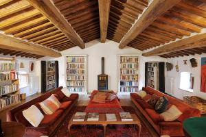 a large living room with couches and a fireplace at Castello Di Potentino in Seggiano