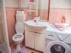 a bathroom with a toilet and a sink and a washing machine at Old town apartmant in Dubrovnik