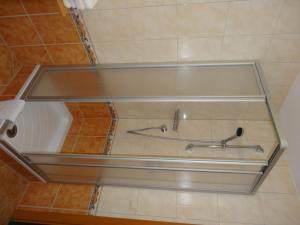 a bathroom with a tub with a faucet at Köflerhof Appartements in Sankt Leonhard im Pitztal