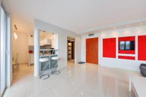 米茲多洛傑的住宿－Apartamenty Sun & Snow Światowida，一间厨房和客厅,拥有红色和白色的墙壁