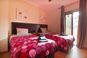 a bedroom with two beds and a window at Prestige for Home Apt Vista Mar 2 Quarteira in Quarteira