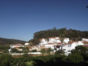 a group of white houses on top of a hill at Residencia Laranjeira in Odeceixe