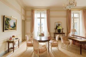 a dining room with a table and chairs at Ritz Paris in Paris
