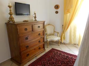 a bedroom with a dresser with a tv on top at Valverde Guest House in Tarquinia