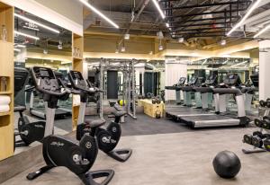 a gym with cardio equipment and tread machines at Stey Beijing Wangfujing Hotel in Beijing