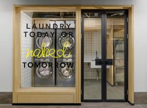 a window of a laundry room with the words laundry today updated tomorrow at Stey Beijing Wangfujing Hotel in Beijing