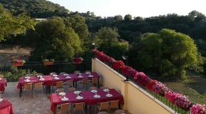 a group of tables with red table cloths on a balcony at Hostal Rural Casa Castro in Alberuela de la Liena
