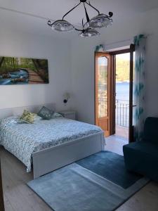 a bedroom with a bed and a sliding glass door at Deluxe Lipari Room in Lipari