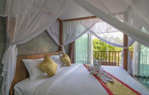 a bedroom with a bed with a canopy at The Country Villa in Ao Nang Beach +70 photos