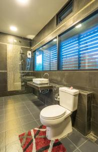 a bathroom with a toilet and a sink at The Country Villa in Ao Nang Beach