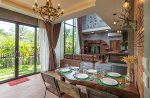 a dining room and living room with a table and chairs at The Country Villa in Ao Nang Beach