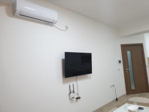 a room with a flat screen tv on a white wall at Ivana Apartments in Gevgelija