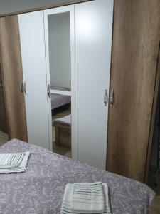 a bedroom with a bed with a mirror and a bed sidx sidx sidx at Ivana Apartments in Gevgelija