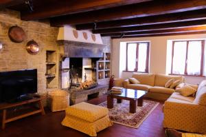 a living room with a couch and a fireplace at Il Palazzo Ridracoli in Bagno di Romagna