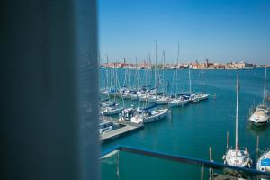 a bunch of boats docked in a harbor at Mosella Suite Hotel in Sottomarina