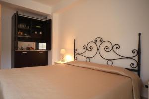 a bedroom with a bed with a metal headboard at La Casa dei Venti - Aeolian Charme in Canneto