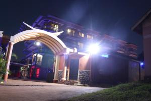 a building with a light in front of it at night at Hotel Jfrigh in Kampala