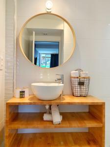 a bathroom with a sink and a mirror at Hôtel Beau Soleil in Le Lavandou