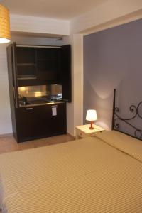 a bedroom with a bed and a large television at La Casa dei Venti - Aeolian Charme in Canneto