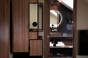 a bathroom door with a mirror and a sink at Hotel D Geneva in Geneva +47 photos