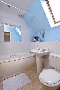 a bathroom with a white toilet and a sink at Tweed Cottage in Jedburgh