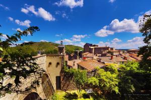 a village on a hill with a blue sky at Hôtel de la Villeon in Tournon-sur-Rhône +58 photos